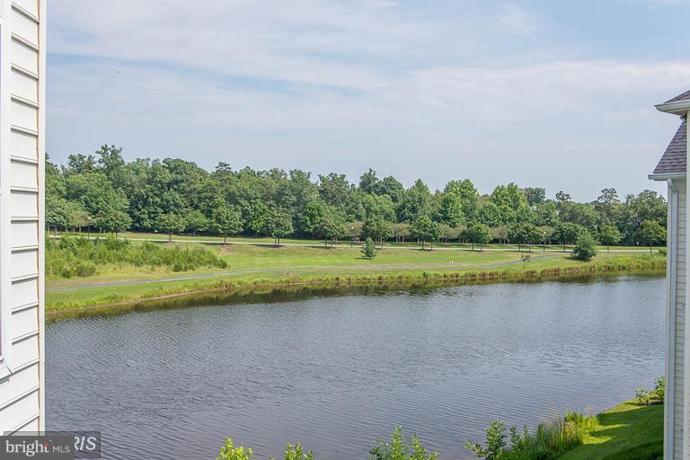 25252 Riffleford Square, Unit 101 Chantilly, VA 20152 - Photo 25 of 30 a view of a lake with a big yard