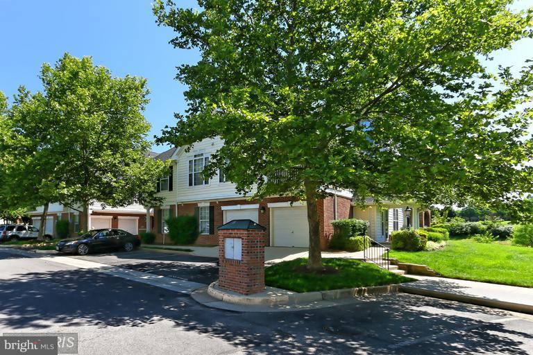 25252 Riffleford Square, Unit 101 Chantilly, VA 20152 - Photo 27 of 30 a front view of a house with a garden