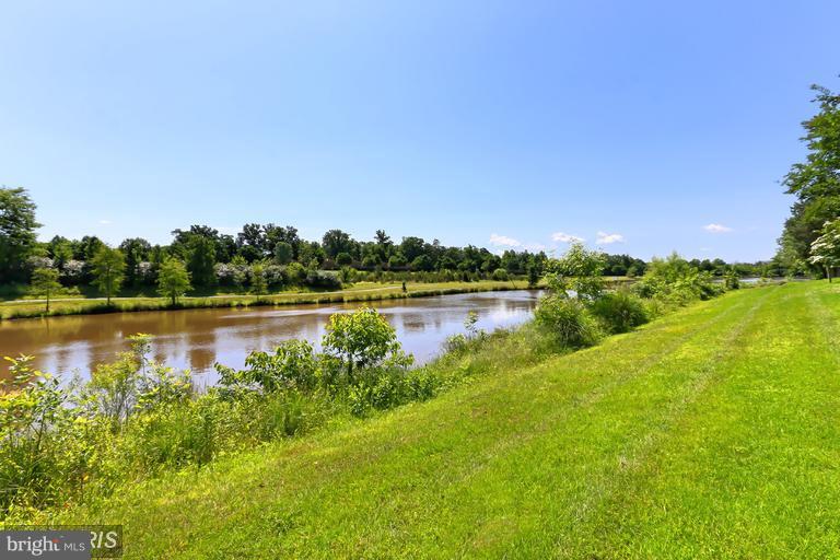 25252 Riffleford Square, Unit 101 Chantilly, VA 20152 - Photo 28 of 30 a view of a lake with houses in the back