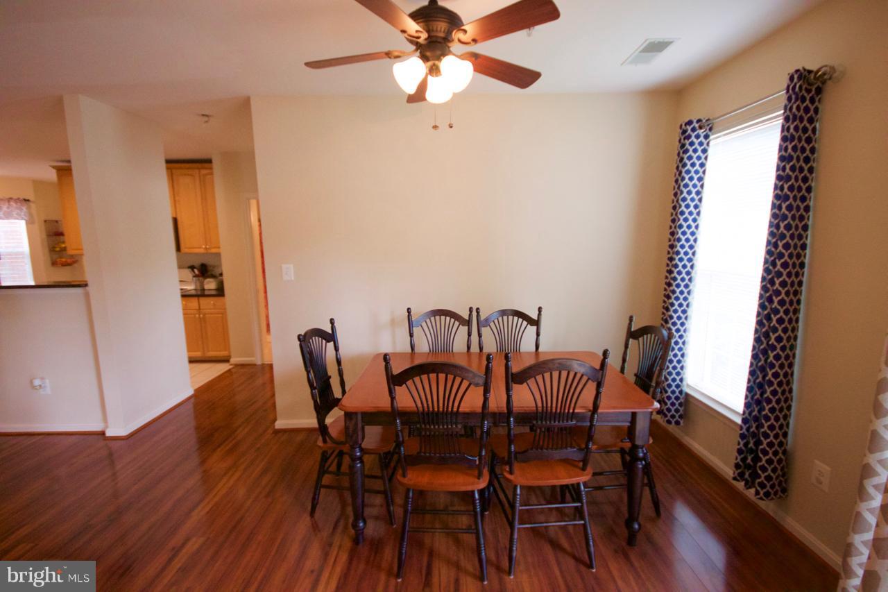25252 Riffleford Square, Unit 101 Chantilly, VA 20152 - Photo 5 of 30 a view of a dining room with furniture and wooden floor