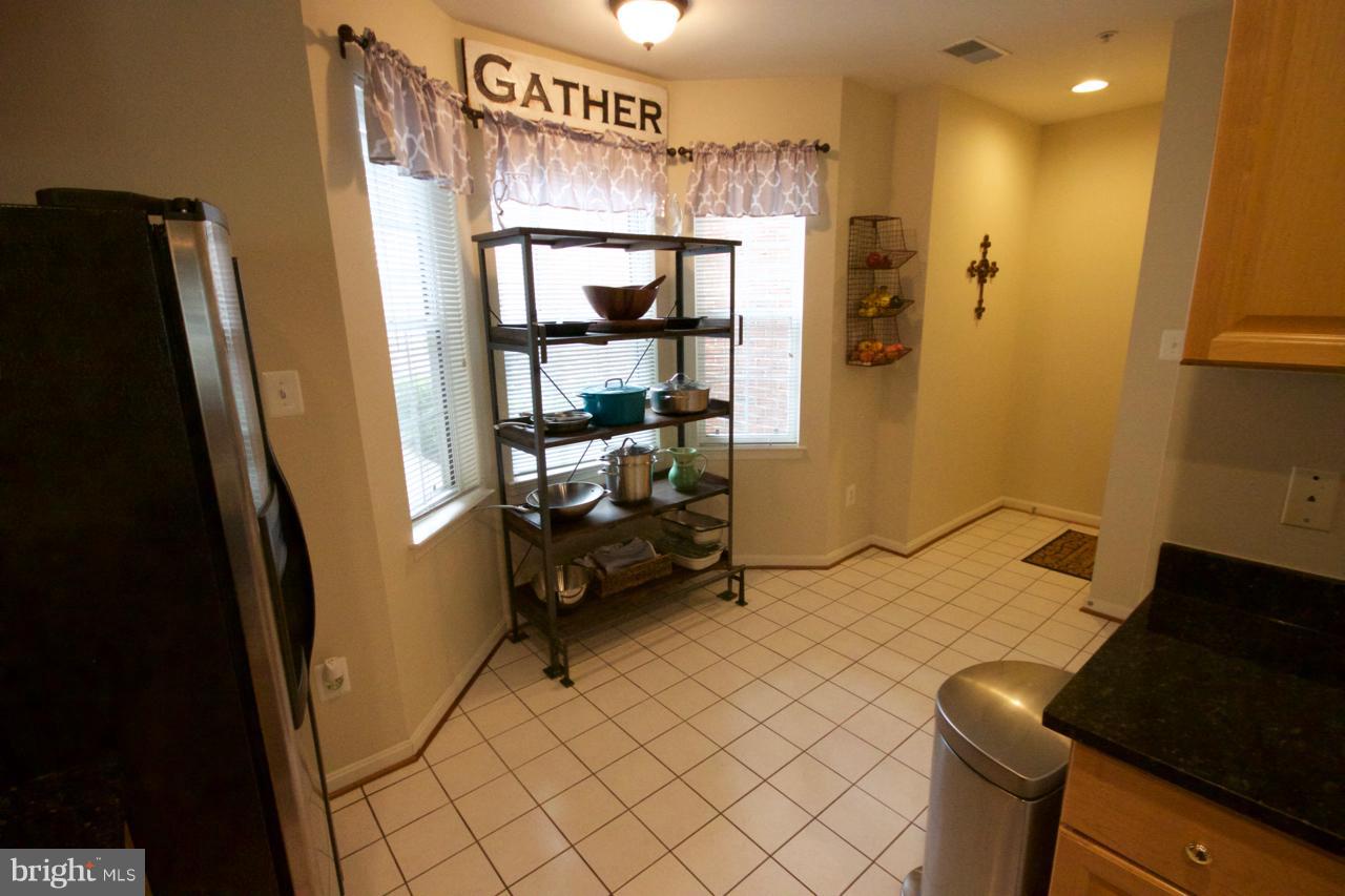 25252 Riffleford Square, Unit 101 Chantilly, VA 20152 - Photo 8 of 30 a bedroom with a bed and a mirror