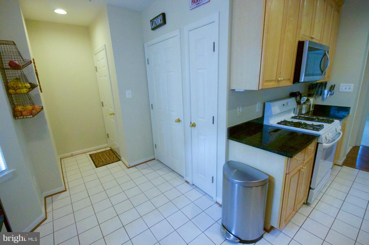 25252 Riffleford Square, Unit 101 Chantilly, VA 20152 - Photo 10 of 30 a kitchen with a sink and a stove top oven