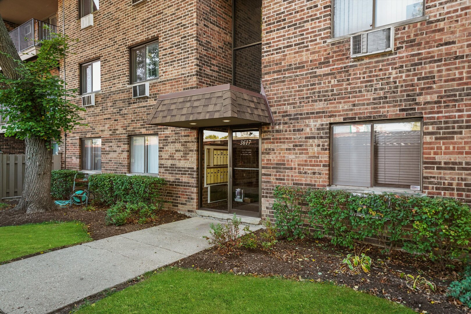 3617 Central Avenue East, Unit 201 Glenview, IL 60025 - Photo 1 of 21 a view of a brick house with a large windows and flower plants