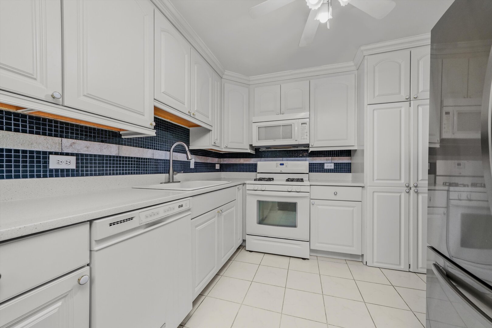 3617 Central Avenue East, Unit 201 Glenview, IL 60025 - Photo 10 of 21 a kitchen with white cabinets and appliances