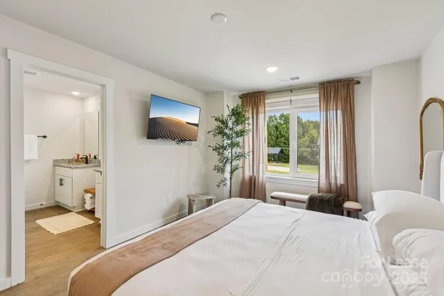 a bedroom with a bed and a flat screen tv