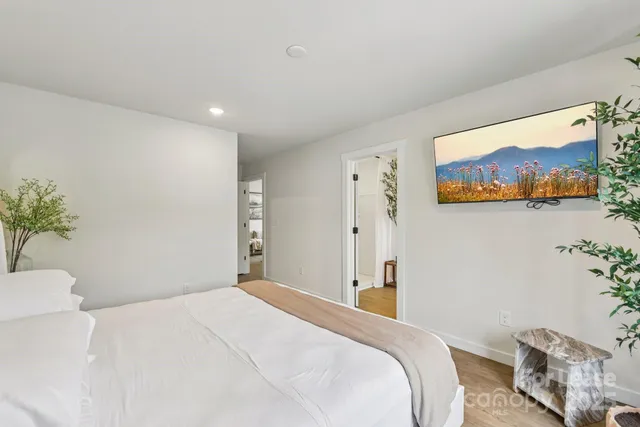 a bedroom with a bed and a painting on the wall