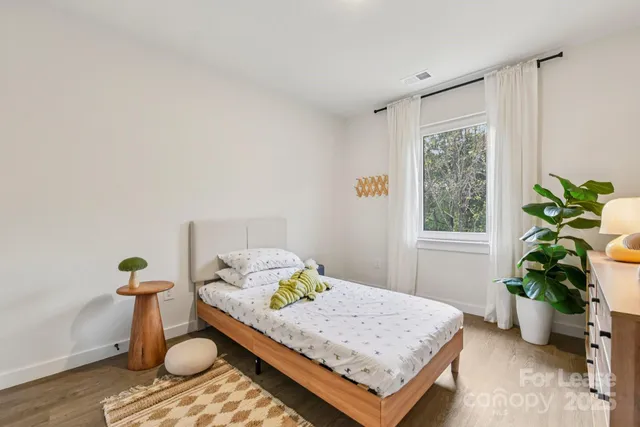 a bedroom with a bed and window