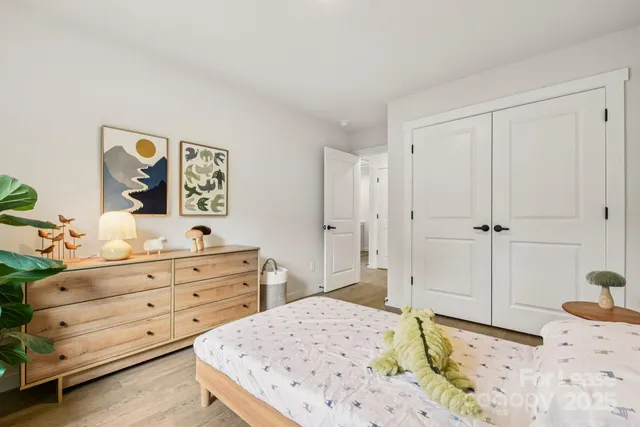 a bedroom with a bed and a dresser in it