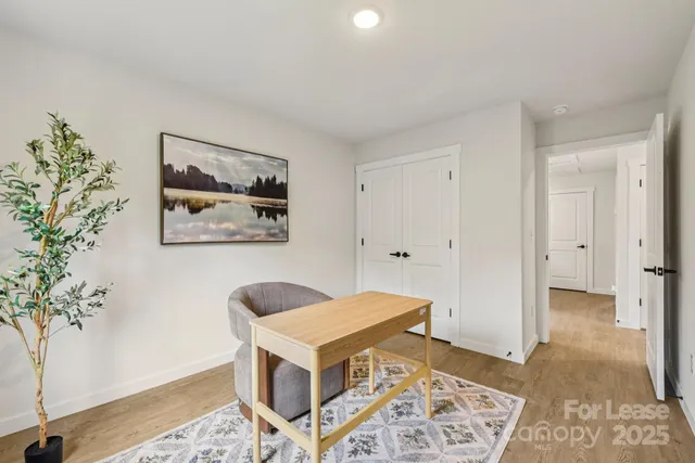 a bedroom with furniture and a potted plant
