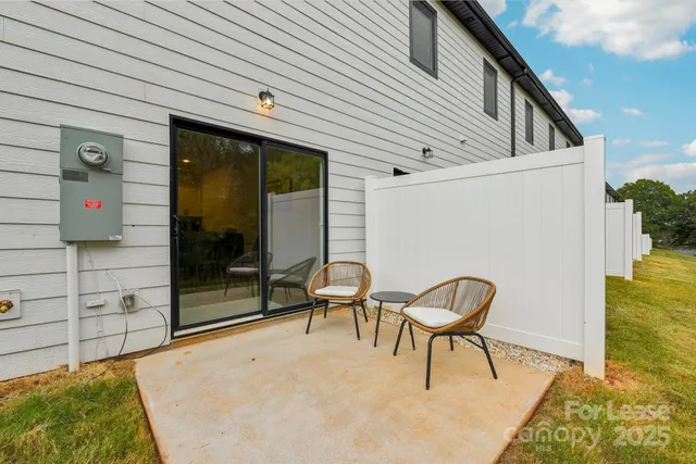 a backyard of a house with table and chairs