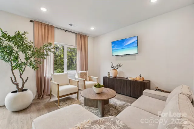 a living room with furniture and a large window