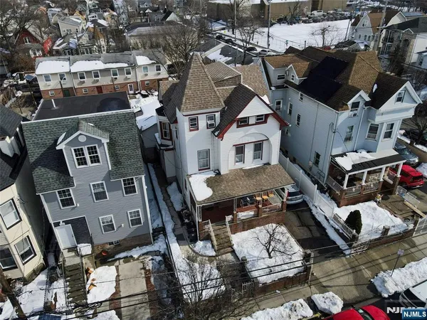 an aerial view of a houses with a city view