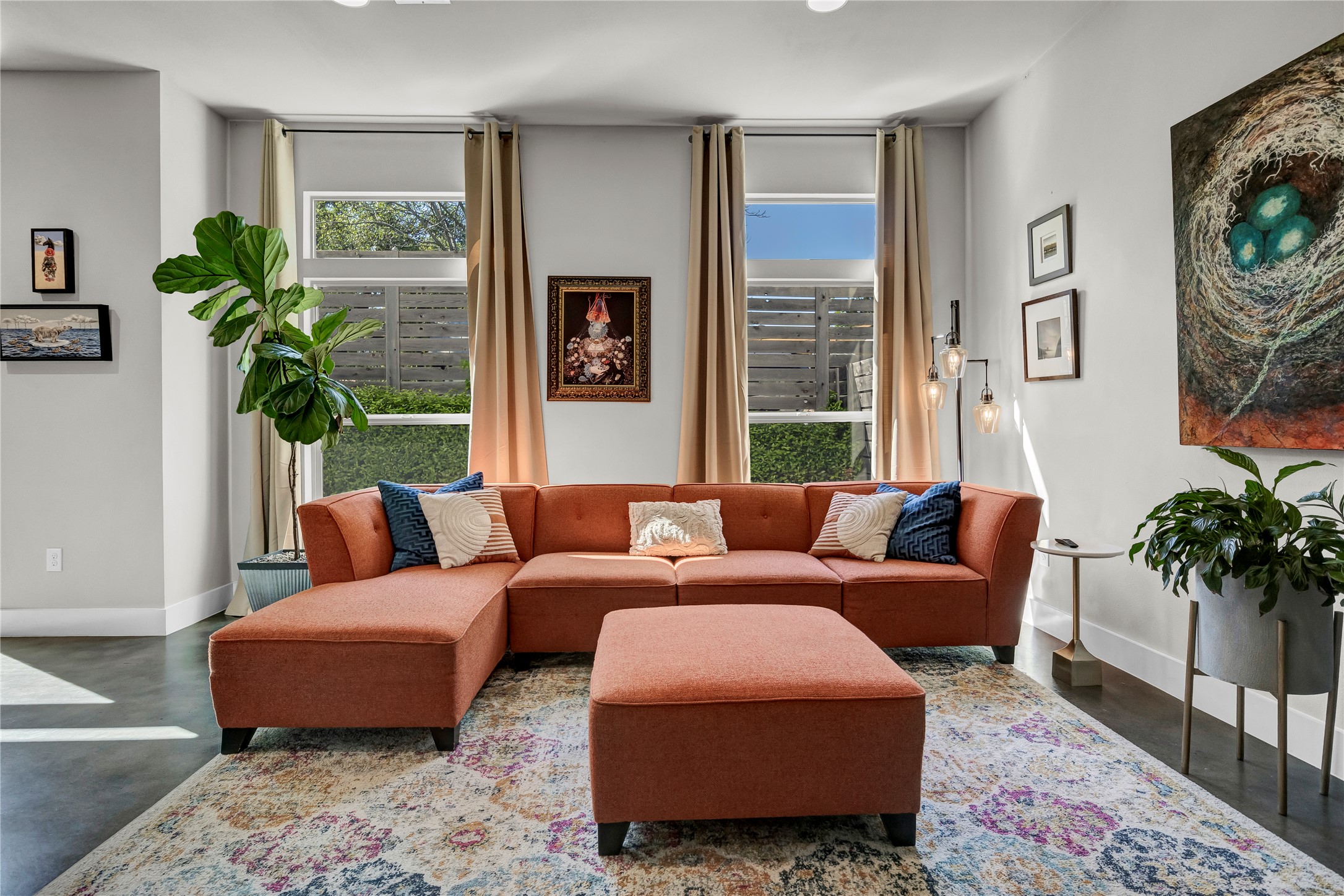 a living room with furniture potted plant and a window