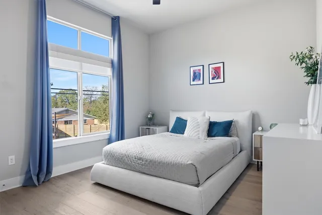 a bedroom with a large bed and a large window