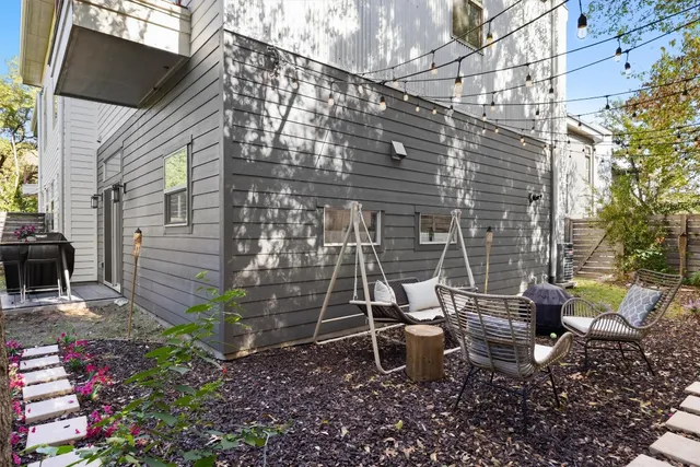 a backyard of a house with outdoor seating