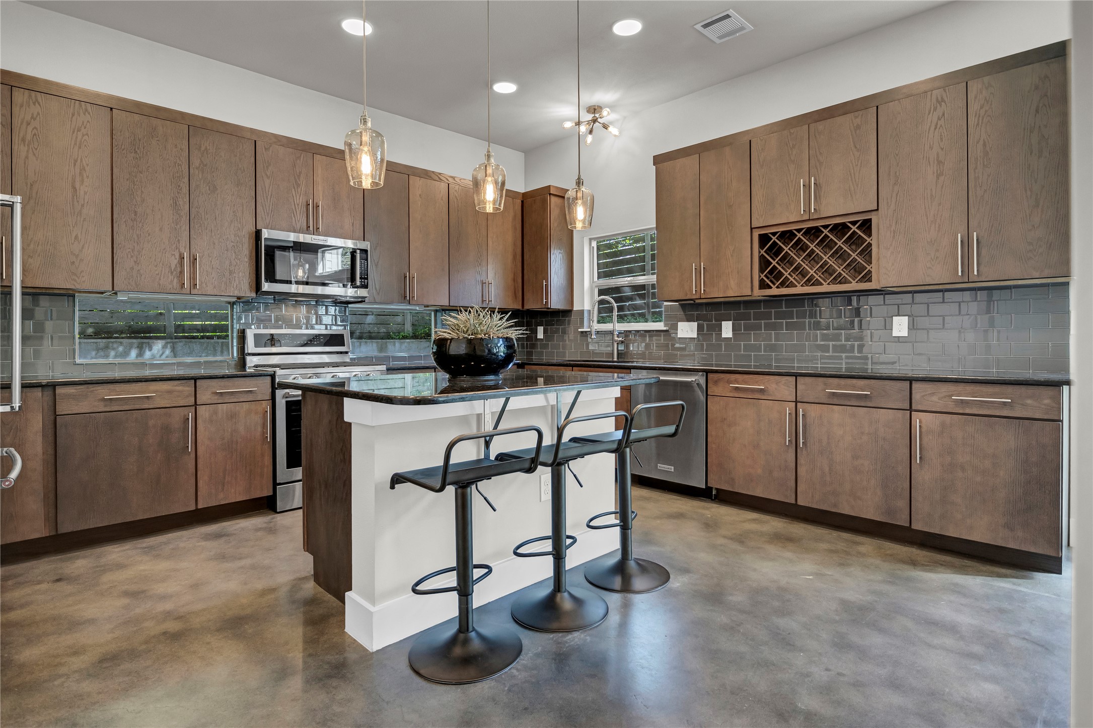 3504 Clawson Road, Unit 7 Austin, TX 78704 - Photo 4 of 26 Kitchen featuring a kitchen breakfast bar, stainless steel appliances, dark stone counters, a center island, and pendant lighting
