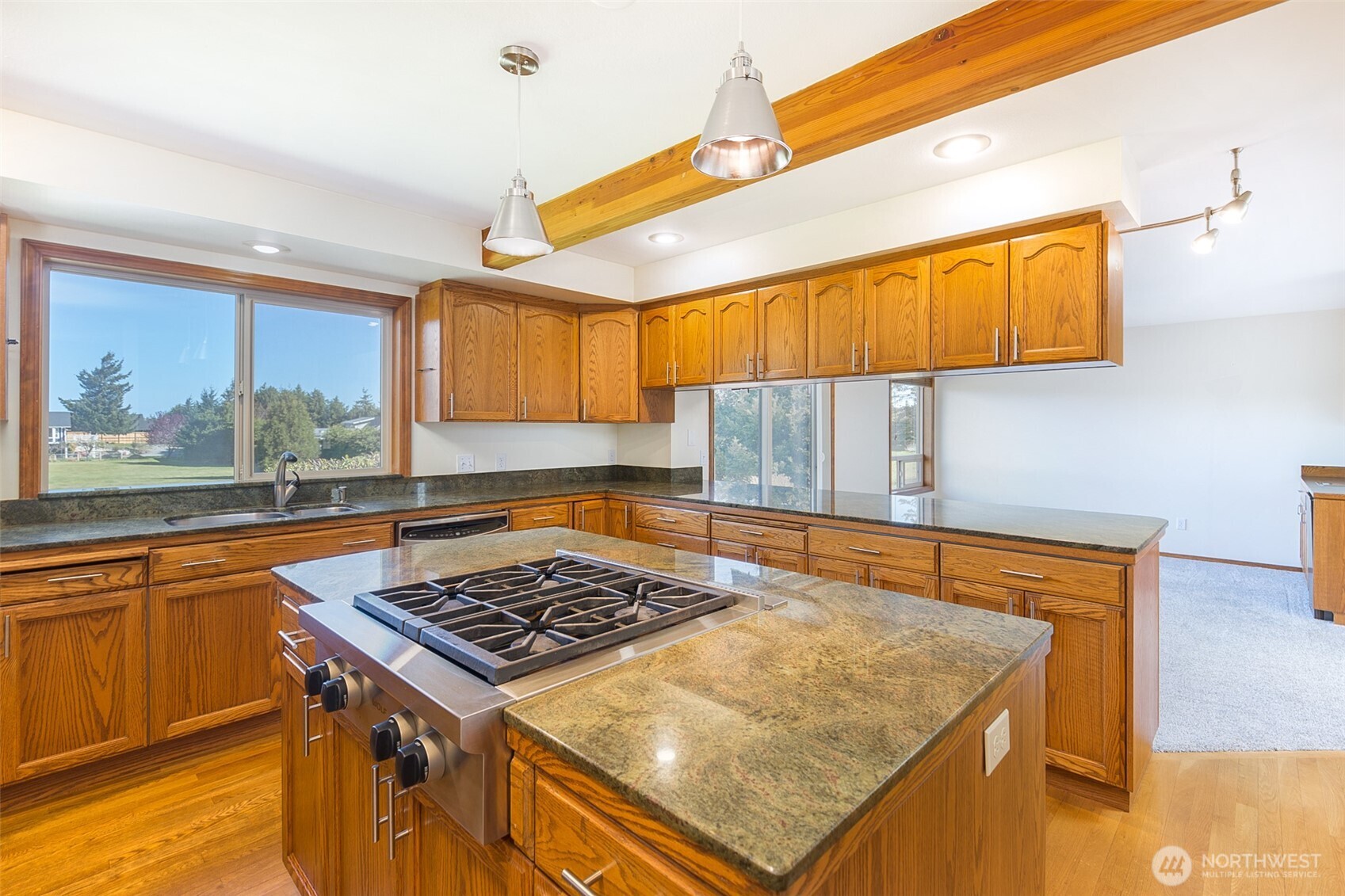 81 Bon Jon View Way Sequim, WA 98382 - Photo 22 of 38 a kitchen with a stove a sink and a wooden cabinets