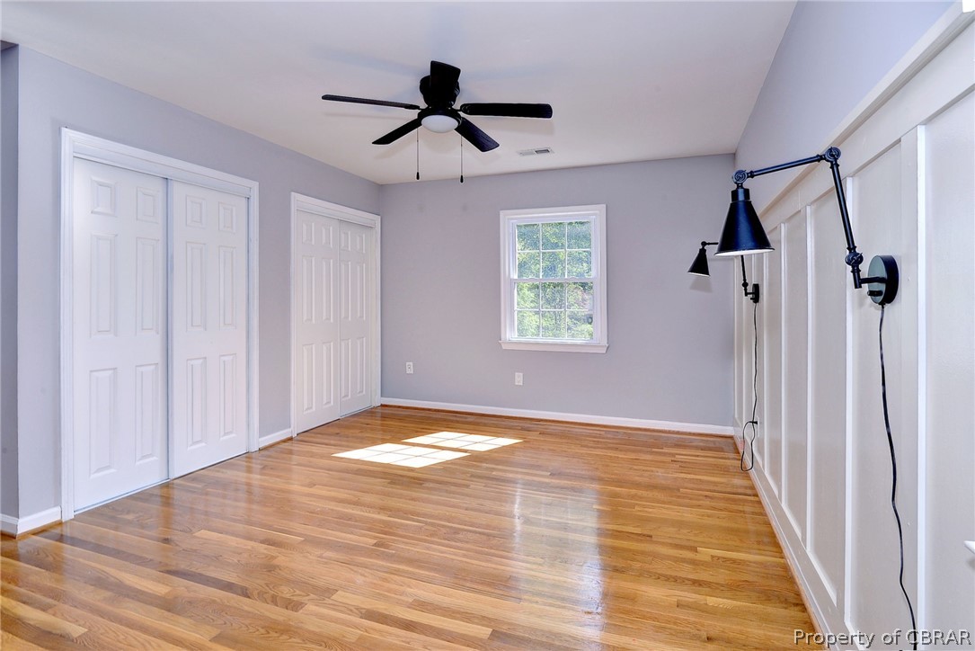 137 Wilderness Road Hampton, VA 23669 - Photo 38 of 45 Unfurnished bedroom with multiple closets, ceiling fan, and light hardwood / wood-style floors