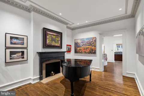 a dining room with furniture a chandelier and wooden floor