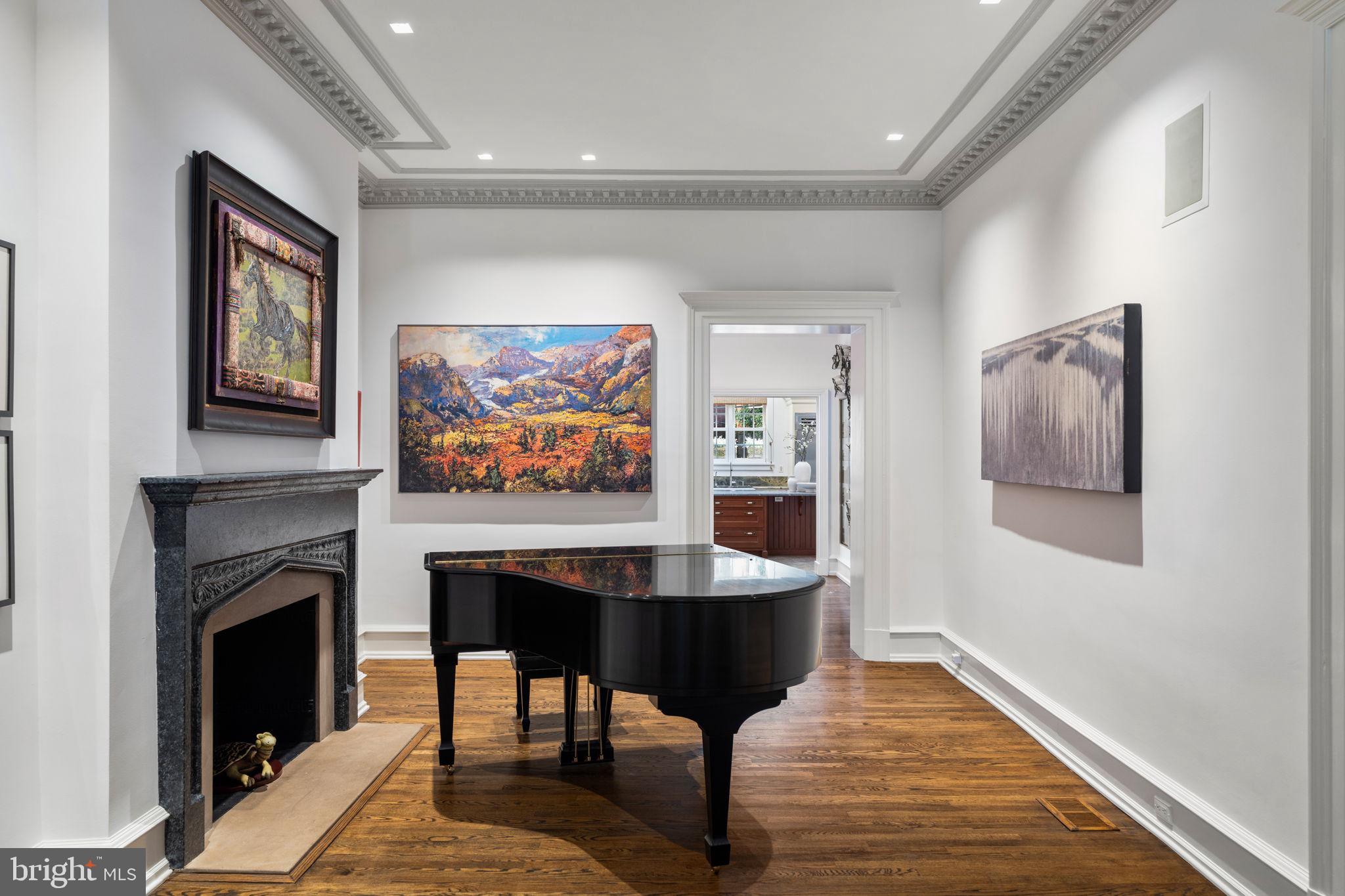 1819 Delancey Place Philadelphia, PA 19103 - Photo 15 of 76 a living room with furniture a fireplace and paintings on wall