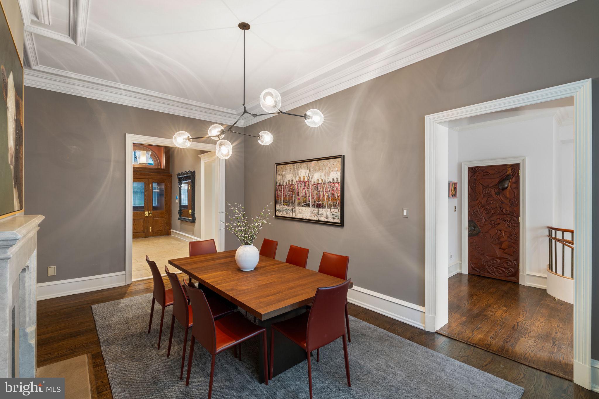 1819 Delancey Place Philadelphia, PA 19103 - Photo 20 of 76 a dining room with wooden floor a chandelier a wooden table and chairs