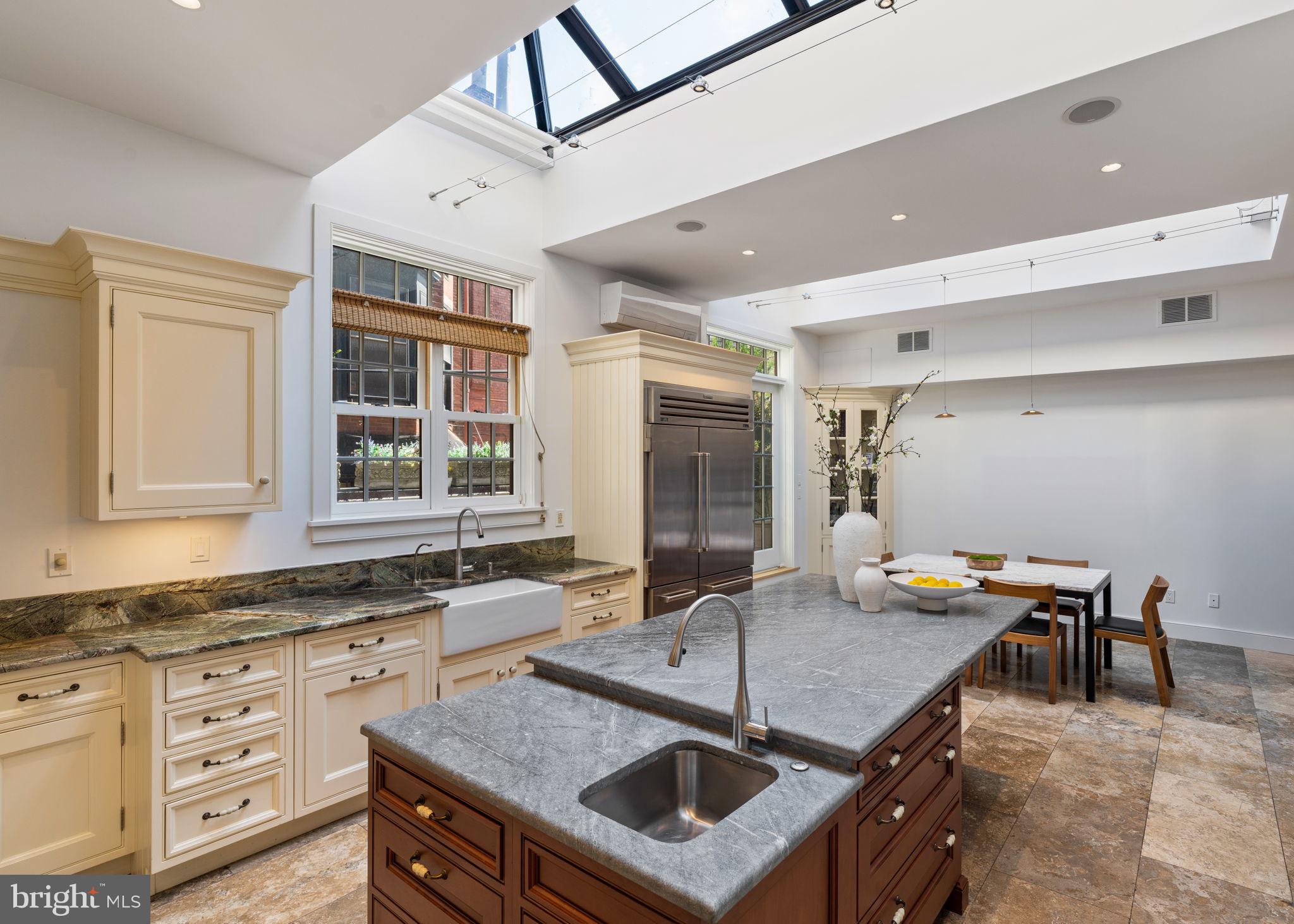 1819 Delancey Place Philadelphia, PA 19103 - Photo 29 of 76 a kitchen with stainless steel appliances granite countertop a stove a sink and a refrigerator