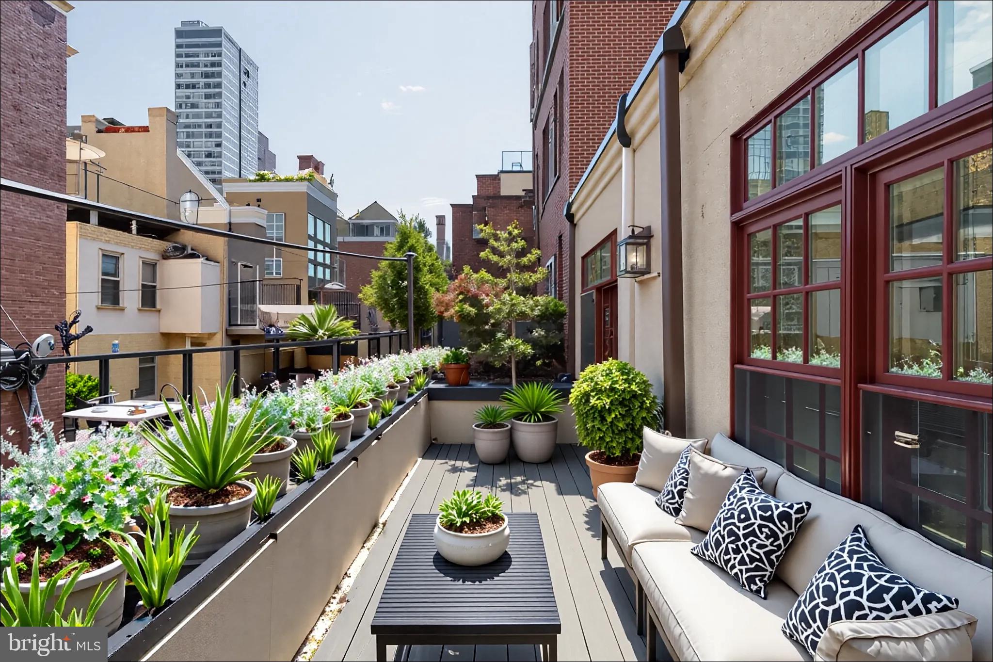 1819 Delancey Place Philadelphia, PA 19103 - Photo 32 of 76 a view of a patio with couches table and chairs and potted plants