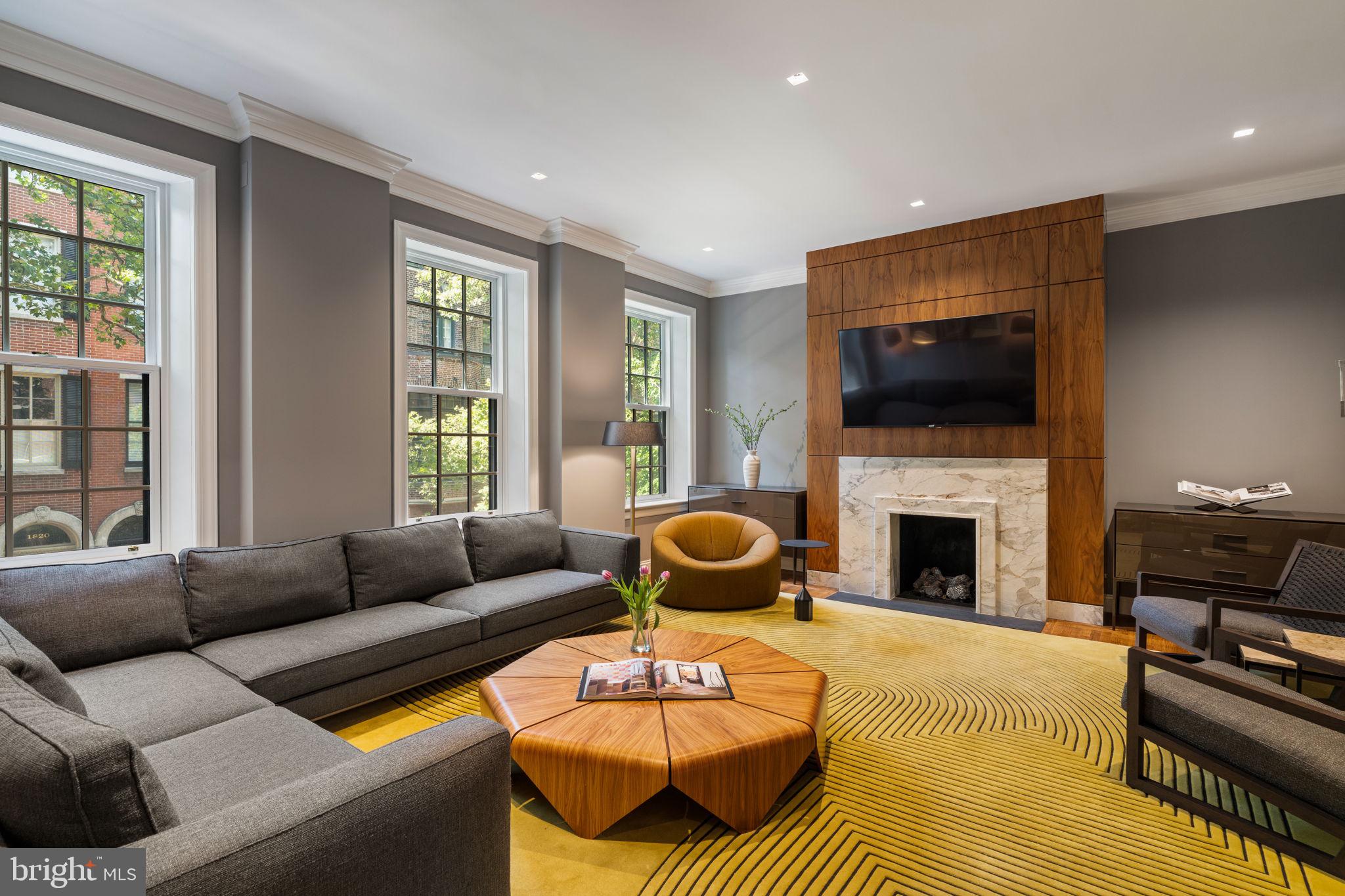 1819 Delancey Place Philadelphia, PA 19103 - Photo 33 of 76 a living room with furniture a flat screen tv and a fireplace