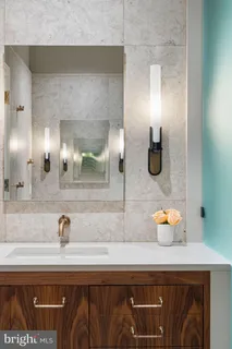 a bathroom with a sink toilet double vanity and shower