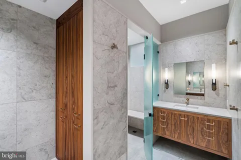 a bathroom with a sink a mirror and a shower