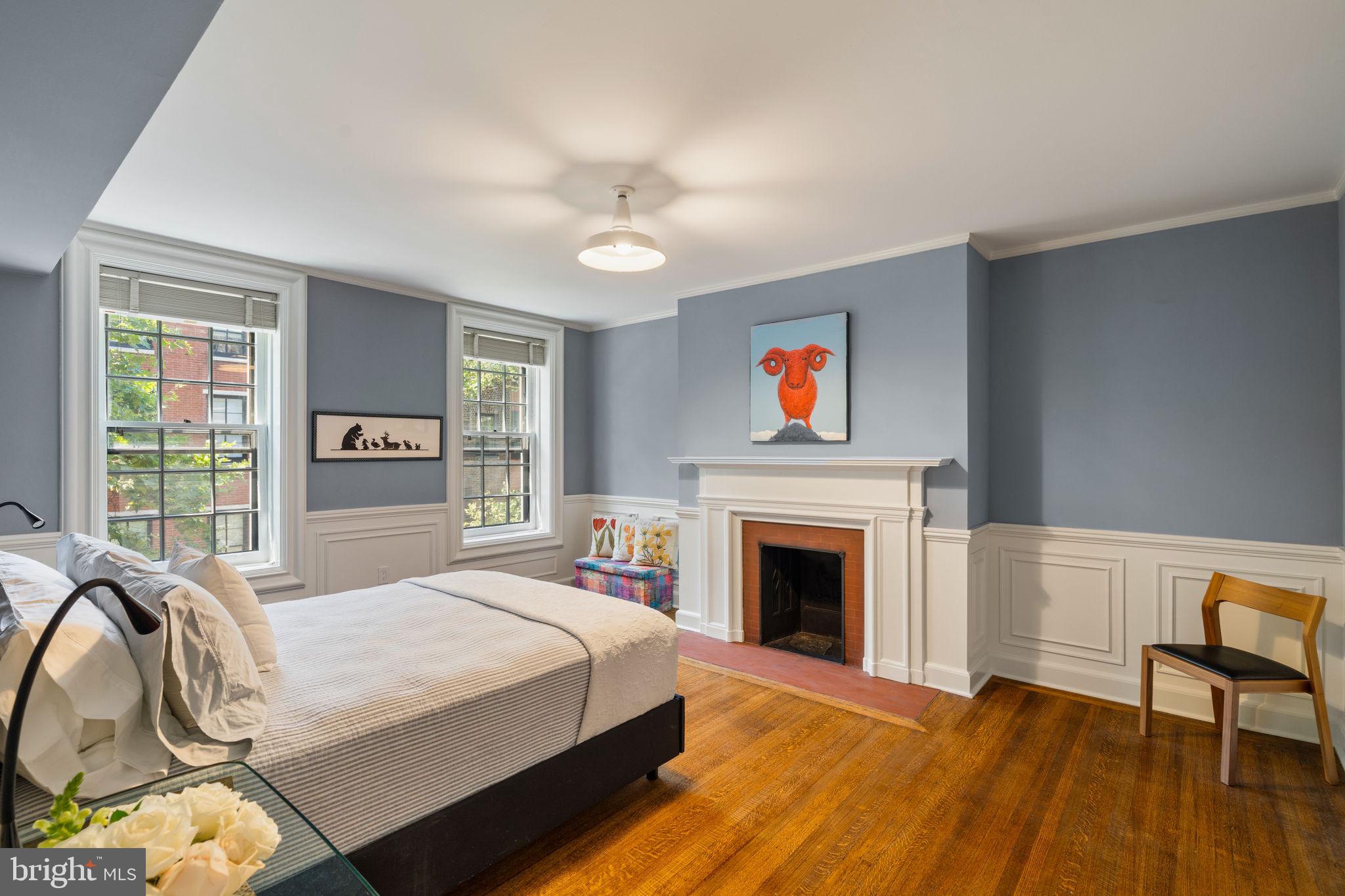 1819 Delancey Place Philadelphia, PA 19103 - Photo 53 of 76 a spacious bedroom with a bed and a fireplace