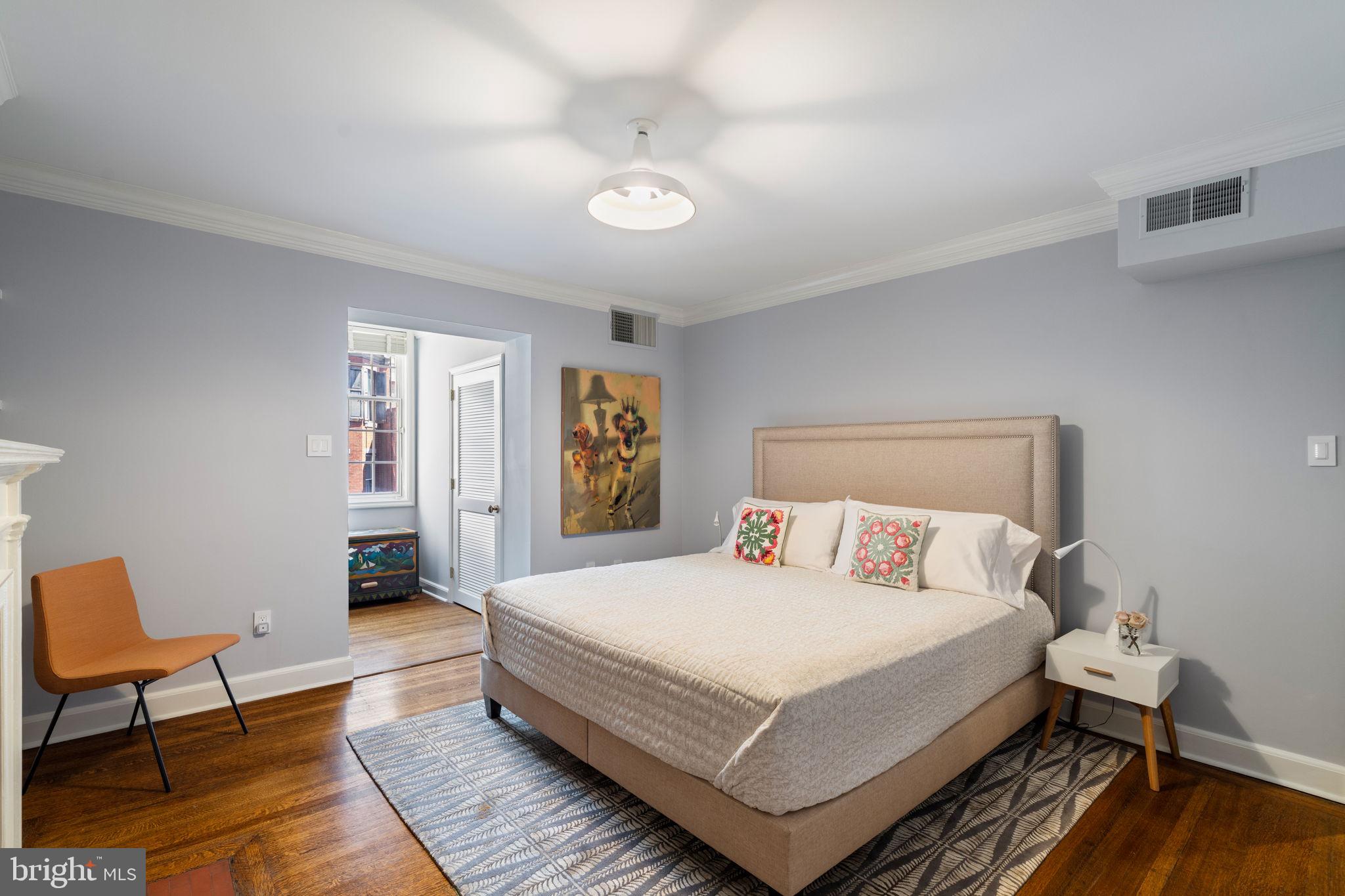 1819 Delancey Place Philadelphia, PA 19103 - Photo 57 of 76 a bedroom with a bed a table and chair