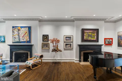 a living room with furniture fireplace and a large window