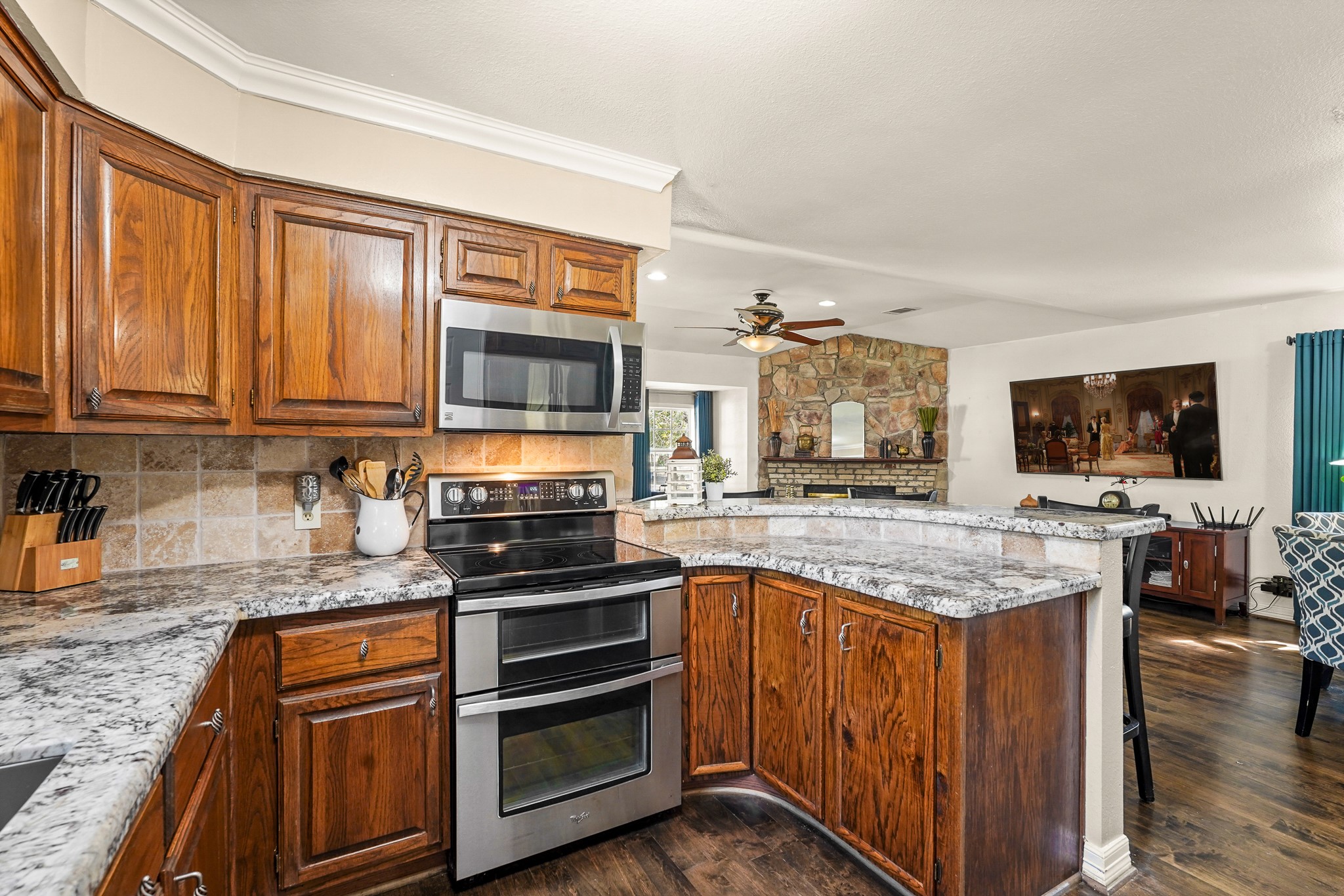 1505 Wagon Road Simonton, TX 77485 - Photo 12 of 50 a kitchen with stainless steel appliances granite countertop a stove and cabinets