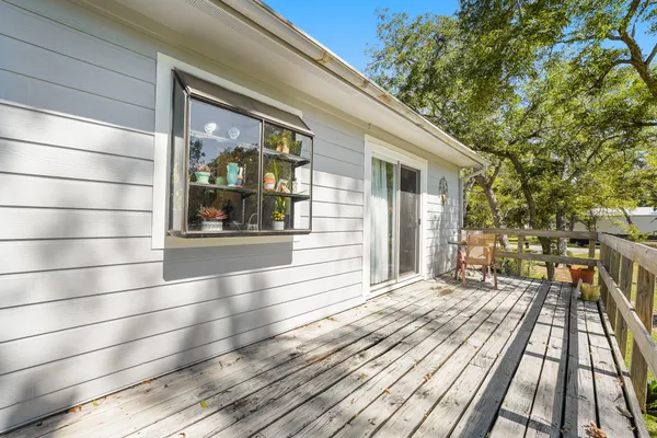 a view of a balcony with wooden floor and outdoor space