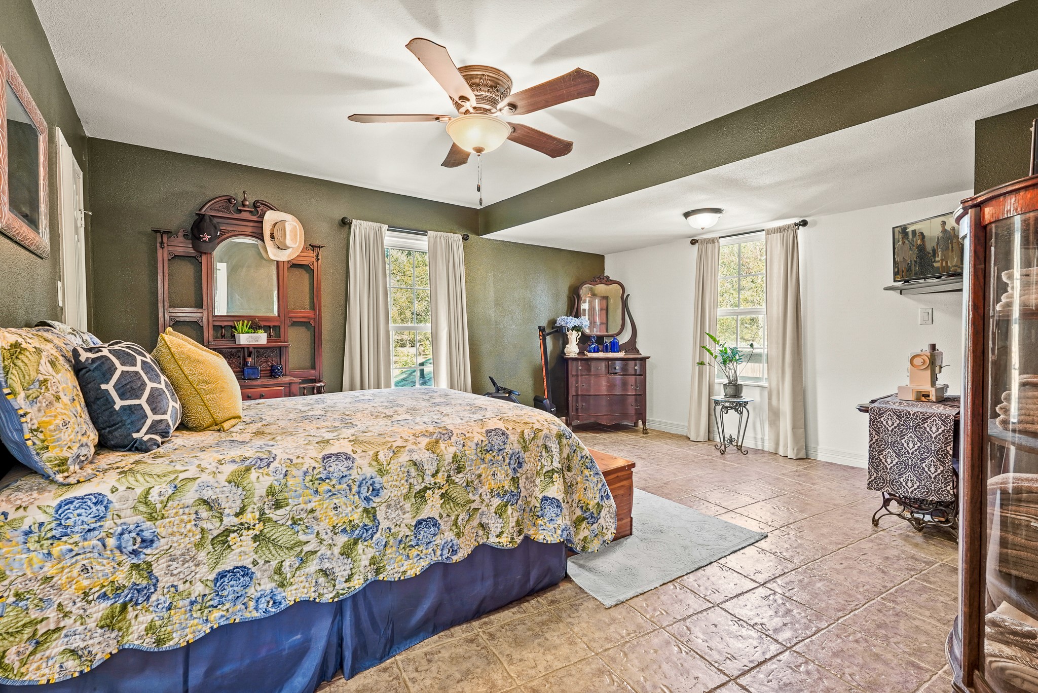 1505 Wagon Road Simonton, TX 77485 - Photo 20 of 50 a bedroom with a large bed and a chandelier