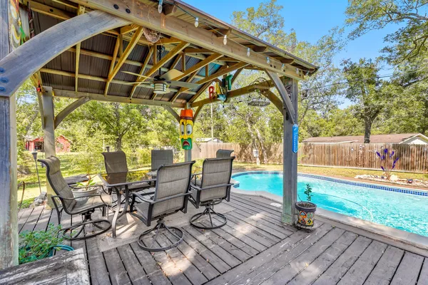 a view of a patio with table and chairs and wooden floor