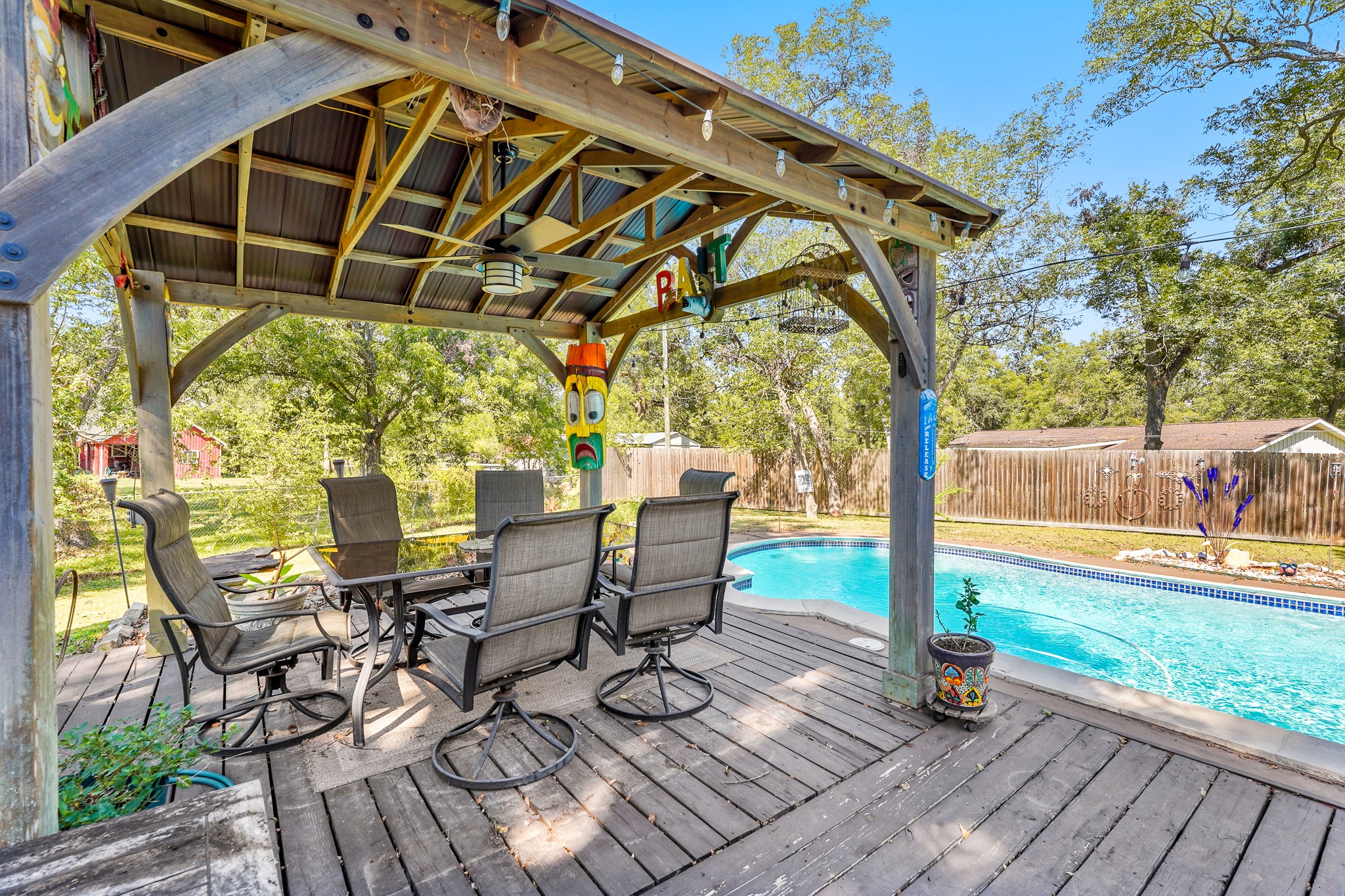 1505 Wagon Road Simonton, TX 77485 - Photo 30 of 50 a view of a patio with table and chairs and wooden floor