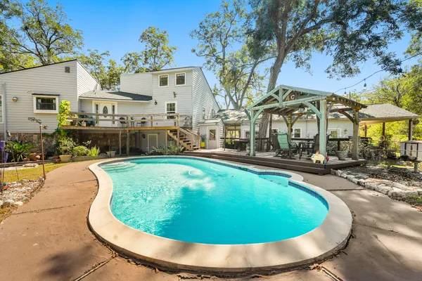 a view of a swimming pool with outdoor seating