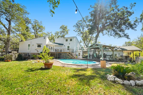 a view of a house with swimming pool and sitting area