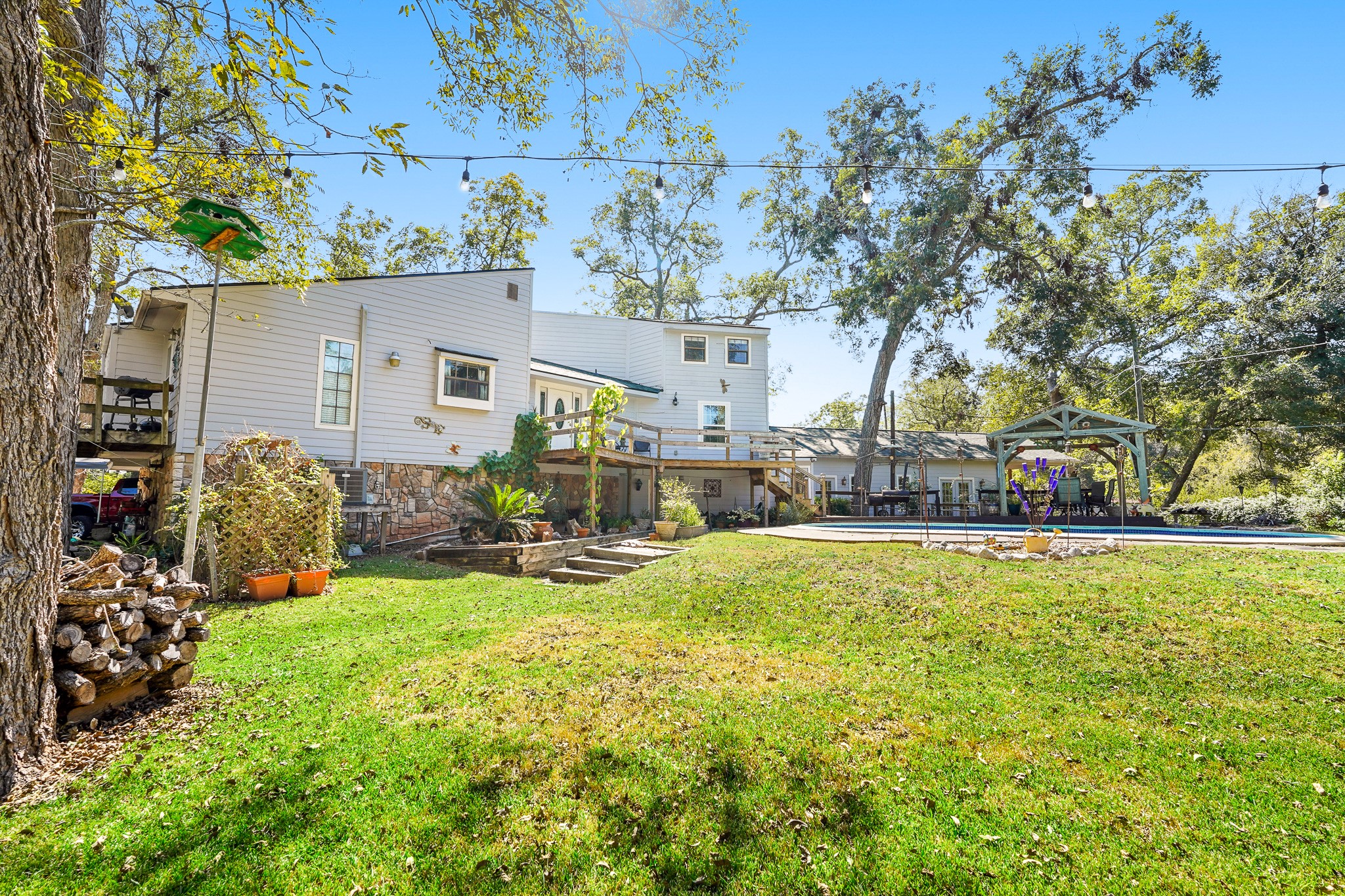 1505 Wagon Road Simonton, TX 77485 - Photo 34 of 50 a view of swimming pool with outdoor seating and trees in the background