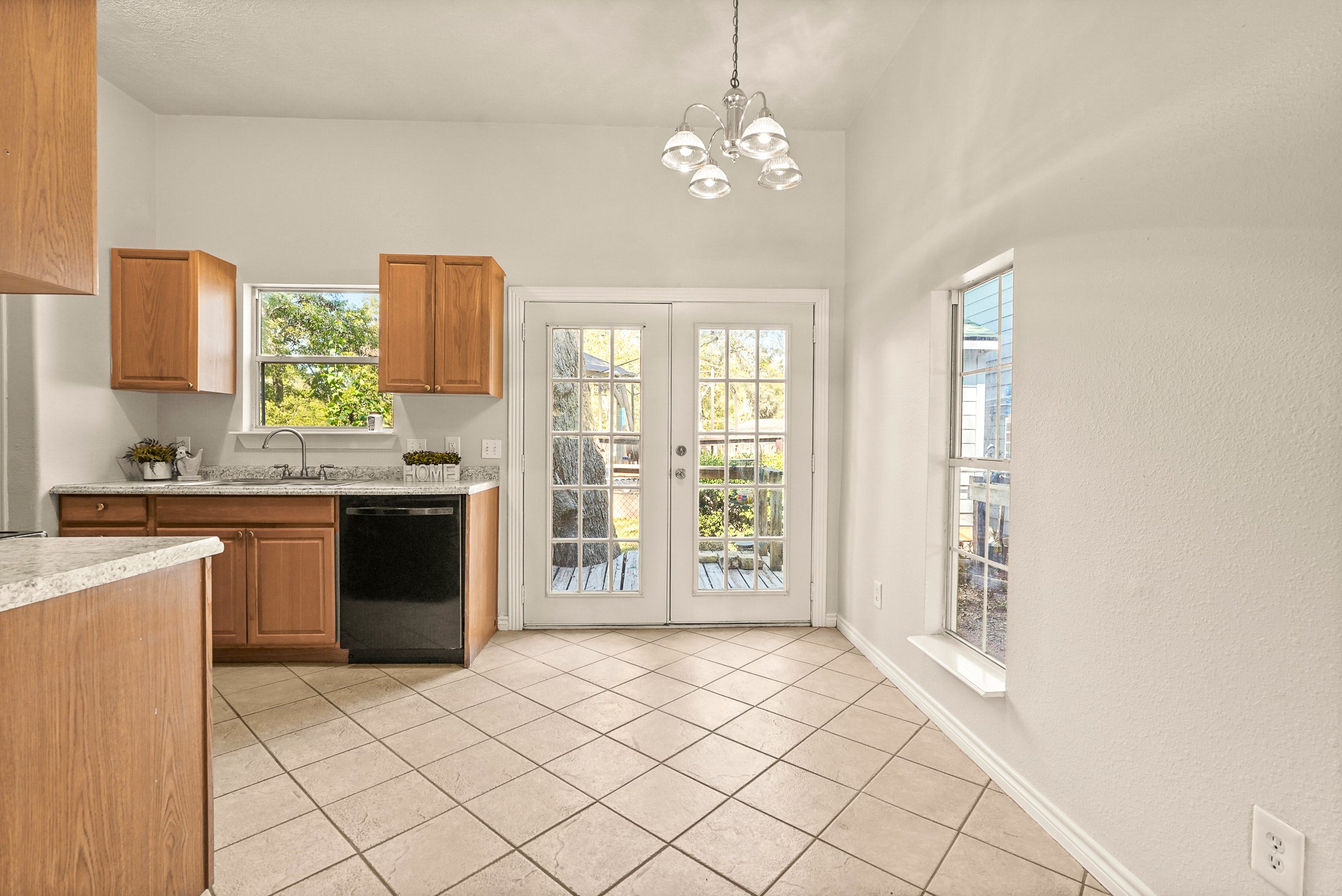 1505 Wagon Road Simonton, TX 77485 - Photo 40 of 50 a large kitchen with kitchen island granite countertop a refrigerator a stove a sink dishwasher with a dining table and chairs