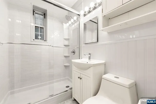 a bathroom with a sink toilet and shower