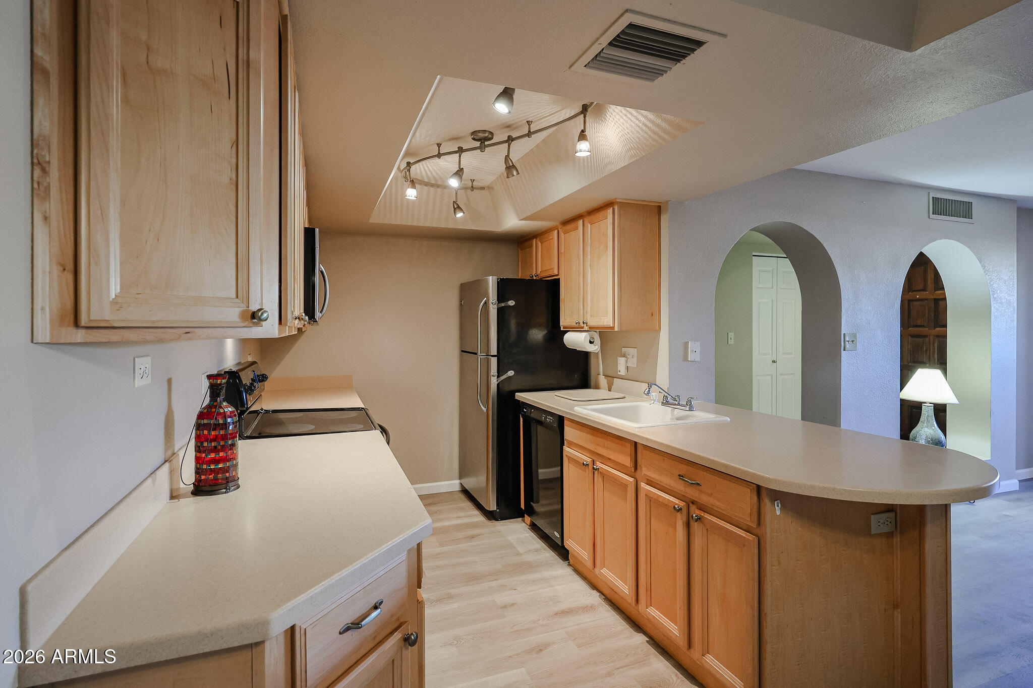10410 North Cave Creek Road, Unit 1011 Phoenix, AZ 85020 - Photo 8 of 54 a kitchen with stainless steel appliances a stove a chimney a sink and cabinets