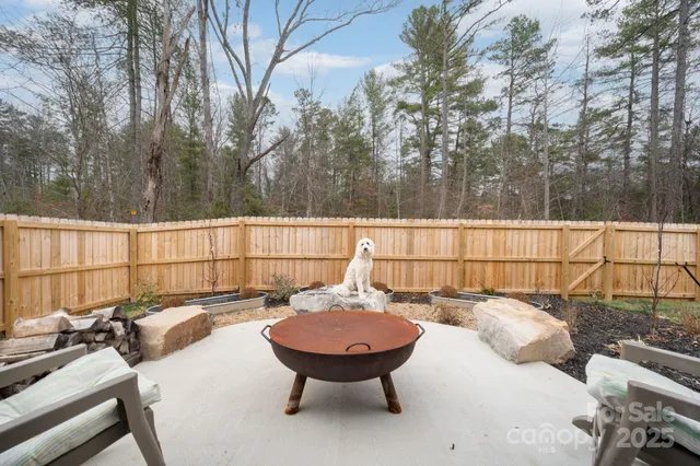 a backyard of a house with table and chairs