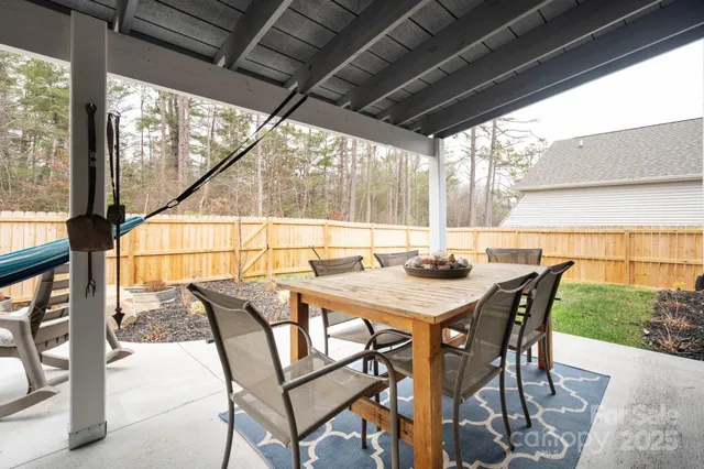 a backyard of a house with table and chairs