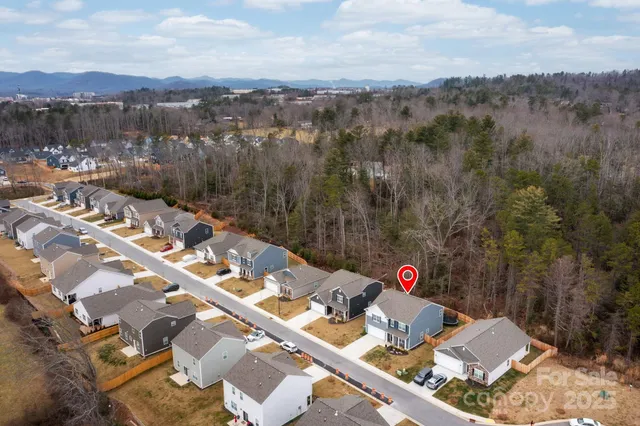 a view of backyard of a house with a table and chairs