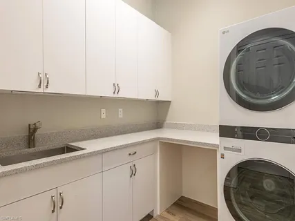 a kitchen with a sink and a washer dryer