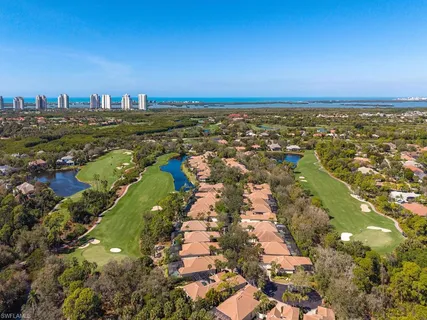 an aerial view of a house with swimming pool and outdoor seating