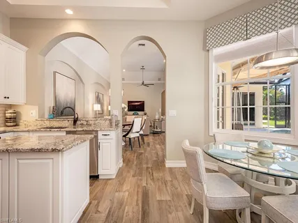 a large kitchen with kitchen island a island a sink stainless steel appliances and cabinets